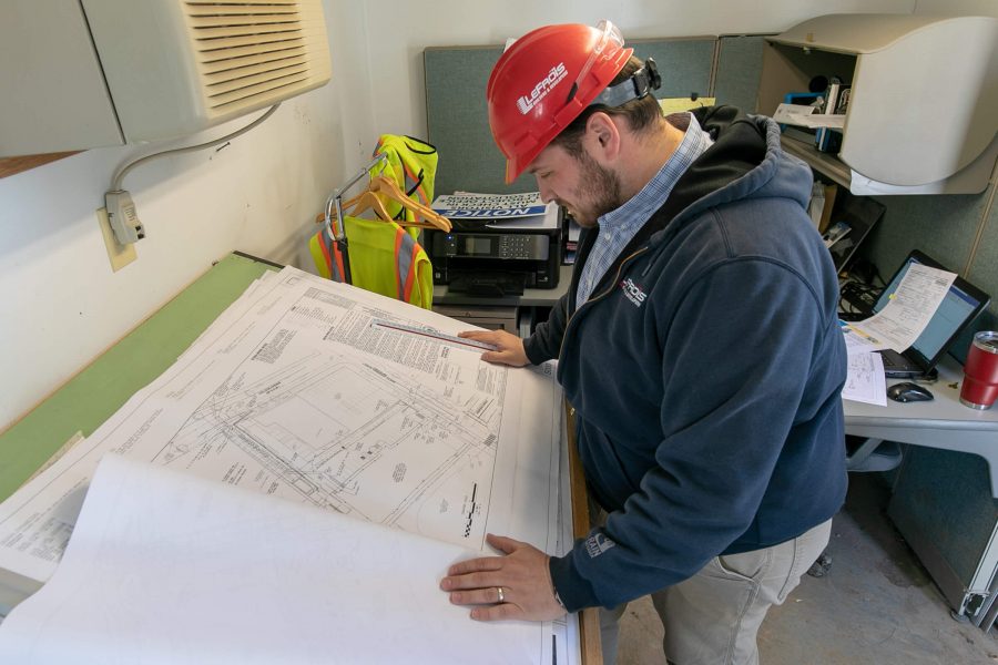 A LeFrois team member studying construction plans